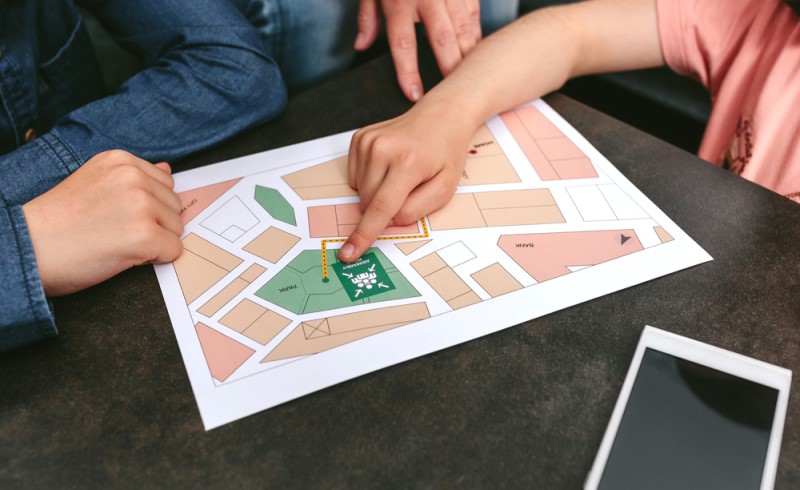 Color photo of a family meeting showing a designated meeting location on a map for all family members, in case of a disaster or emergency.