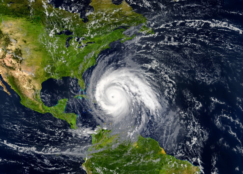Color satellite view from above the earth observing the development of a hurricane approaching the East coast of the United States.